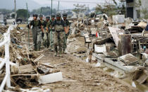 <p>Japan Ground Self-Defense Force members search missing people after flooding caused by heavy rains in Kurashiki, Okayama prefecture, southwestern Japan, Thursday, July 12, 2018. (Photo: Shohei Miyano/Kyodo News via AP) </p>