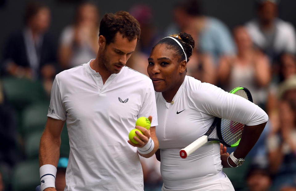 Serena Williams and Andy Murray walk during their mixed doubles match on day eight of the Wimbledon Championships at the All England Lawn Tennis and Croquet Club, Wimbledon.