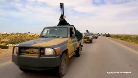 Military vehicles drive on a road in Libya, April 4, 2019, in this still image taken from video. Reuters TV via REUTERS