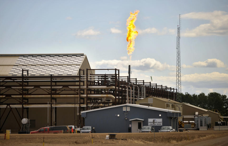 The suspension of steam generation forces this East Primrose steam plant to flare natural gas at Canadian Natural Resources Limited's (CNRL) Primrose Lake oil sands project near Cold Lake, Alberta August 8, 2013. The Alberta Energy Regulator (AER) recently ordered CNRL to restrict steam injection, enhance monitoring, and continue to accelerate cleanup efforts at its Primrose and Wolf Lake high pressure cyclic steam stimulation (HPCSS) project following incidents involving the release of bitumen emulsion to surface. Picture taken August 8, 2013.     REUTERS/Dan Riedlhuber  (CANADA - Tags: ENERGY BUSINESS POLITICS ENVIRONMENT)