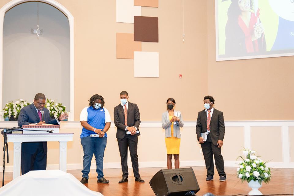 The Rev. Adrian S. Taylor, left, pastor of Springhill Baptist 
Church in southeast Gainesville, recognizes four members of the church who attend college and who recently received a total of $12,500 in scholarships from the church. From left to right are Christopher "CJ" Phillips Jr., Donovan Cooper, Noa Davis and David Hayes