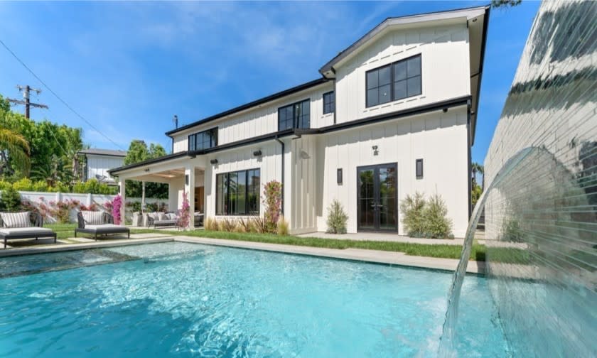 Built in 2020, the five-bedroom farmhouse features wood finishes and black and gold accents across 4,500 square feet.