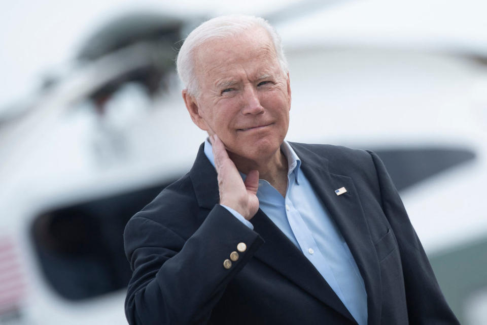 US President Joe Biden wipes his neck after a cicada landed on him while boarding Air Force One at Andrews Air Force Base, before departing for the UK and Europe to attend a series of summits.