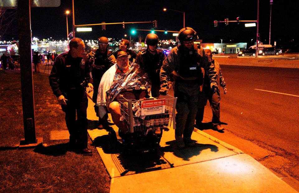 <p>Patrick Carnes is evacuated in a Walmart cart by SWAT medics from the scene of a shooting at a Walmart where Carnes was shopping in Thornton, Colo., Nov. 1, 2017. (Photo: Rick Wilking/Reuters) </p>