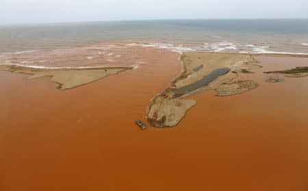 An aerial view of the mouth of Rio Doce (Doce River), which was flooded with mud after a dam owned by Vale SA and BHP Billiton Ltd burst, at an area where the river joins the sea on the coast of Espirito Santo in Regencia Village, Brazil, November 23, 2015. REUTERS/Ricardo Moraes