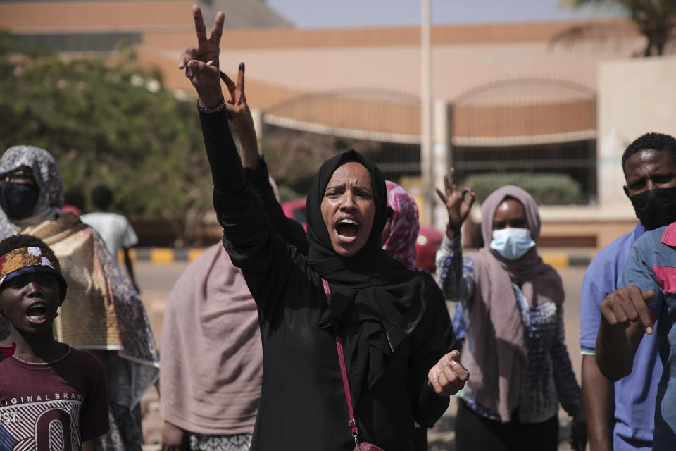 A woman chants slogans during a protest in Khartoum, Sudan, Saturday, Oct. 30, 2021. Pro-democracy groups called for mass protest marches across the country Saturday to press demands for re-instating a deposed transitional government and releasing senior political figures from detention. (AP Photo/Marwan Ali)