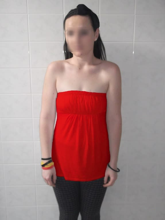 The picture used for the color manipulation in Experiment 3 (the face of the female target was intact in the experiment but is blurred here to protect privacy). The shirt color was red or green.