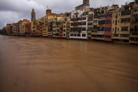 The river Onyar is seen swollen during a storm in Girona, Spain, on Thursday, Jan. 23, 2020. Since Sunday the storm has hit mostly eastern areas of Spain with hail, heavy snow and high winds, while huge waves smashed into towns on the Mediterranean coast and nearby islands of Mallorca and Menorca. (AP Photo/Emilio Morenatti)