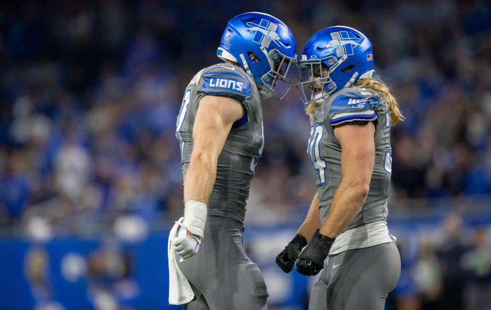 Detroit Lions defensive end Aidan Hutchinson, left, celebrates with teammate Alex Anzalone after a tackle vs. the Minnesota Vikings at Ford Field in Detroit on Sunday, Jan. 7, 2024.