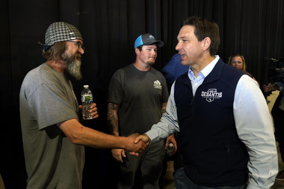 Republican presidential candidate Florida Gov. Ron DeSantis greets a worker during a campaign event at Port Neal Welding, Wednesday, May 31, 2023, in Salix, Iowa. (AP Photo/Charlie Neibergall)