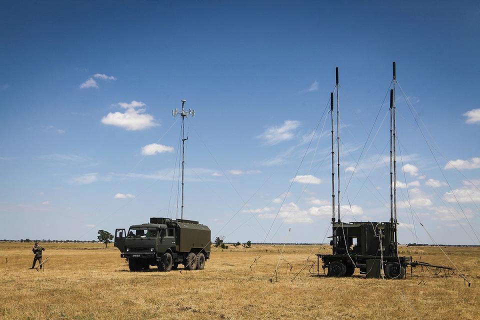 Vehicles with tall poles attached to them.