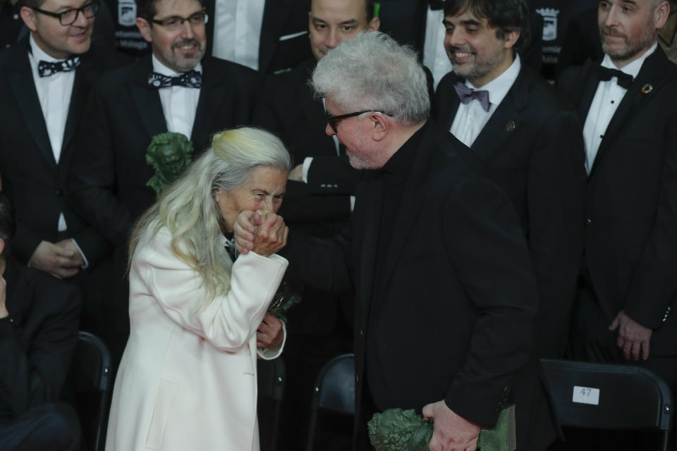 Spanish film director Pedro Almodovar, right, is greeted by Spanish actress Benedicta Sanchez before posing for a group photo during the Goya Film Awards Ceremony in Malaga, southern Spain, early Sunday, Jan. 26, 2020. The annual Goya Awards are Spain's main national film awards. (AP Photo/Manu Fernandez)