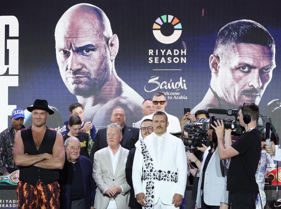British boxer Tyson Fury (L) and Oleksandr Usyk (C-R) of Ukraine pose after attending a press conference in Riyadh, Saudi Arabia (EPA)