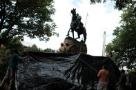 <p>Workers from the City of Charlottesville Parks Department cover the statue of Confederate General Stonewall Jackson in a black tarp in Charlottesville, Va., Aug. 23, 2017. (Photo: Justin Ide/Reuters) </p>