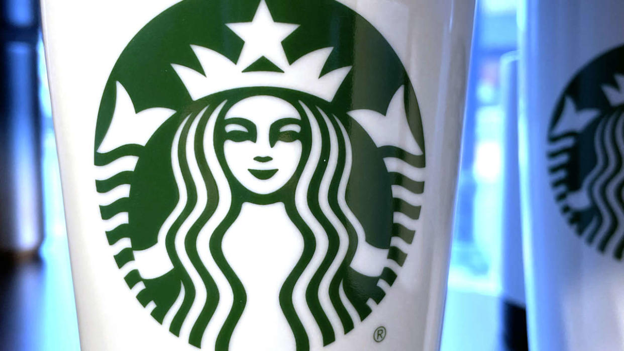 The Starbucks emblem on reusable coffee cup in Annapolis, Maryland, on February 2, 2023, ahead of earnings report. (Photo by Jim WATSON / AFP)