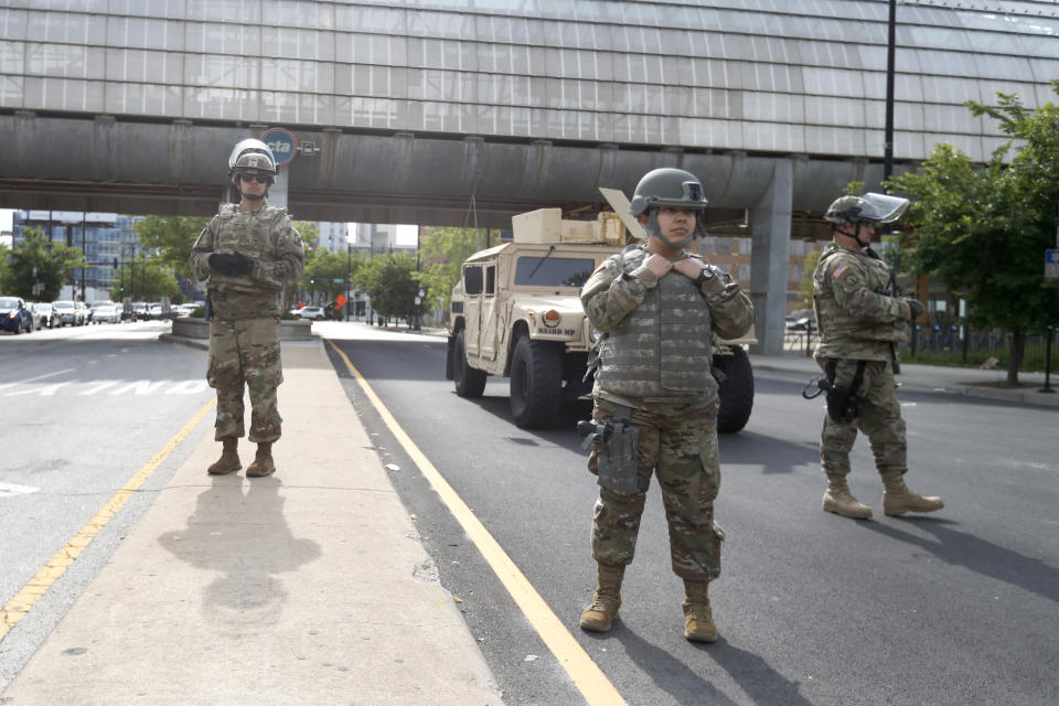 Members of an Illinois National Guard Military Police stand a post, Monday, June 1, 2020, at a security perimeter on Chicago's near Southside. (AP Photo/Charles Rex Arbogast)