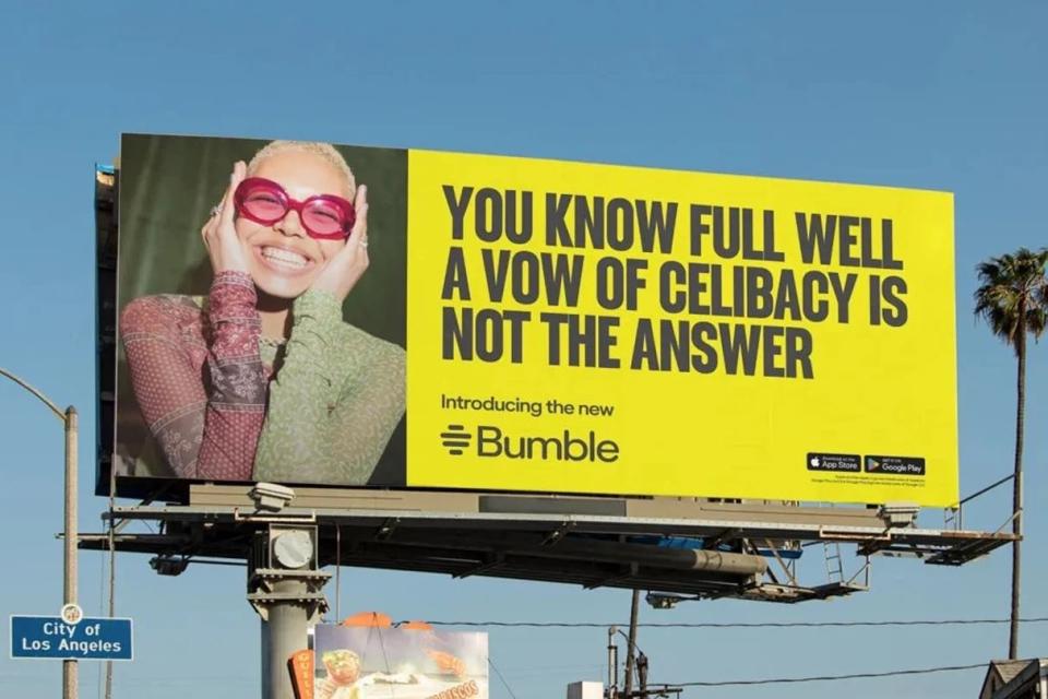 A cheerful person wearing glasses and a sheer top is featured on a billboard with the text: "You know full well a vow of celibacy is not the answer. Introducing the new Bumble."