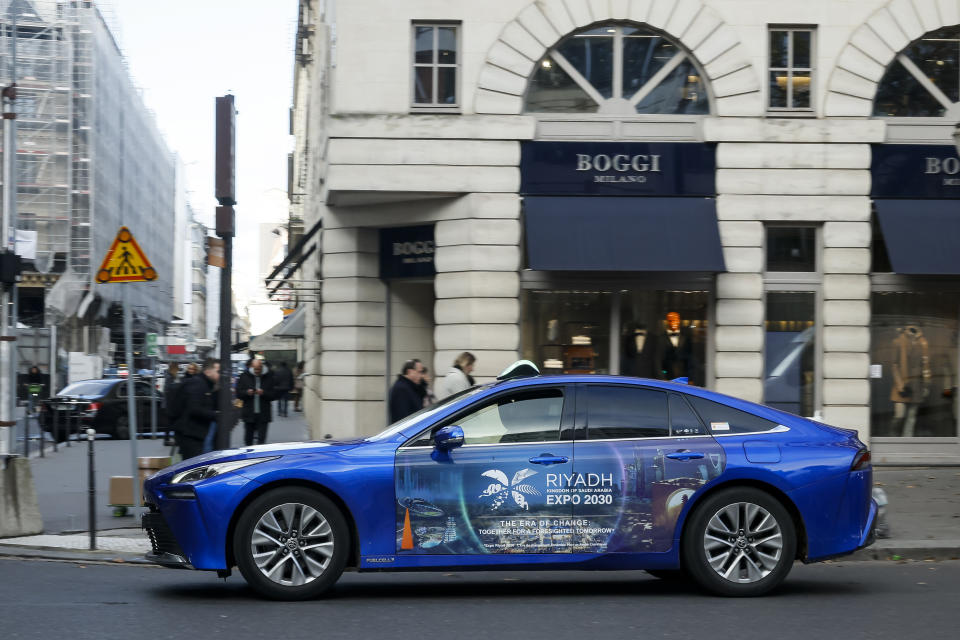 A taxi is decorated with a commercial for the Riyadh Expo 2030, Tuesday, Nov. 28, 2023 in Paris. In a high-profile showdown, Rome, Busan and Riyadh are the top contenders to become the host city of the 2030 World Expo, with the organizing body choosing the winner on Tuesday. (AP Photo/Thomas Padilla)