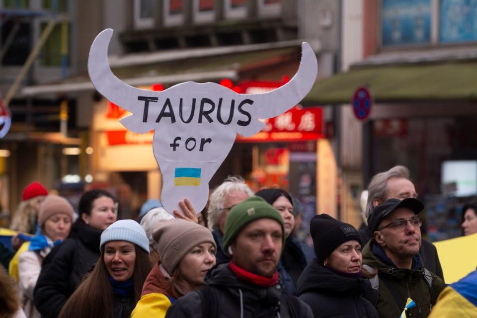 A sign of the "Taurus missile" is visible while hundreds of people are participating in a demonstration to show support for Ukraine, where a 100-meter-long Ukrainian flag is being carried, in Cologne, Germany, on Jan. 6, 2024. (Ying Tang/NurPhoto via Getty Images)