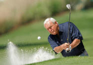 Arnold Palmer hits from a sand trap during the annual Masters Par 3 golf tournament at the Augusta National Golf Club in Augusta, Georgia. REUTERS/Hans Deryk