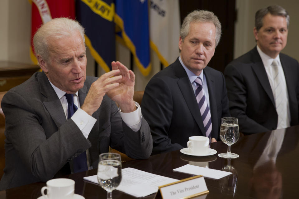 FILE - In this Thursday, Jan. 23, 2014, file photo, Vice President Joe Biden, left, speaks during a meeting with U.S. mayors including Louisville, Ky. Mayor Greg Fischer, center, to discuss workforce development, in the Roosevelt Room of the White House in Washington. As Congress was debating a massive COVID-19 relief plan earlier in 2021, some governors and mayors pleaded that a federal infusion of money was needed immediately to help their communities recover. Now that they got it, some state and local officials are taking their time before actually spending the windfall. (AP Photo/Jacquelyn Martin, File)