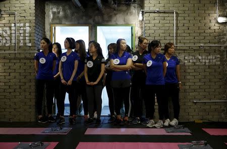 Participants gather before the start of a workout session during TV program "The Body Show" at a gym in Seoul, September 19, 2015. REUTERS/Kim Hong-Ji