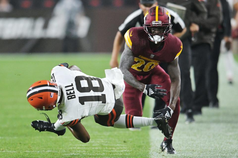 Cleveland Browns wide receiver David Bell (18) is tackled by Washington Commanders safety Jartavius Martin (20) during the first half Aug. 12 in Cleveland.