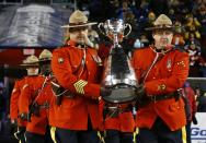 The Grey Cup is carried into the stadium by members of the Royal Canadian Mounted Police (RCMP) prior to the start of the CFL's 103rd Grey Cup championship football game between the Ottawa Redblacks and the Edmonton Eskimos in Winnipeg, Manitoba, November 29, 2015. REUTERS/Mark Blinch