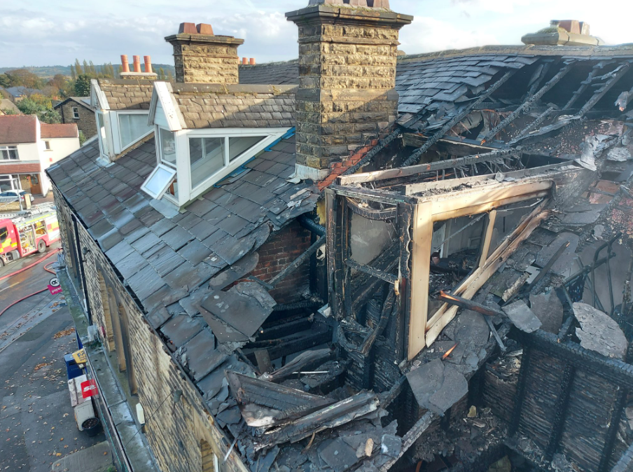 A fire as a result of a tumble dryer at a house in Mirfield left the property blackened and damaged. (Twitter/@WYFRSFireInvest)