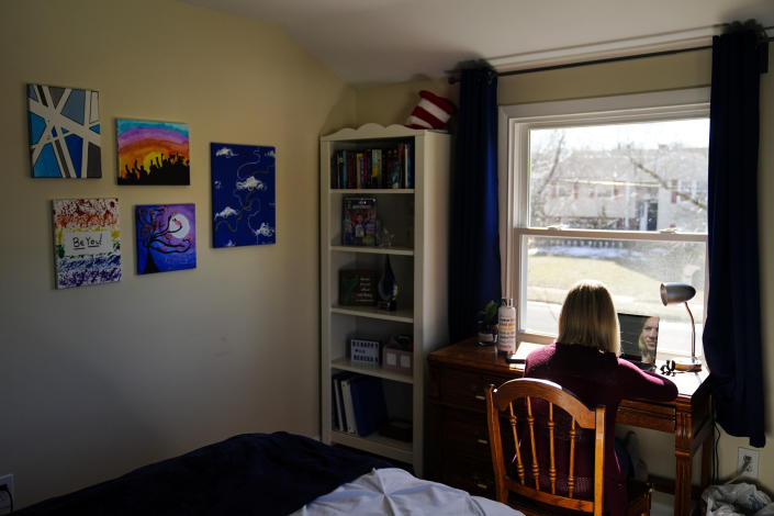 Rebekah Bruesehoff, 14, works on school assignments at home in New Jersey, Friday, Feb. 26, 2021. While New Jersey has a trans-inclusive sports policy, the field hockey player is distressed by proposed bans elsewhere – notably measures that might require girls to verify their gender. “I know what it’s like to have my gender questioned,” Rebekah said. “It’s invasive, embarrassing. I don’t want others to go through that.” (AP Photo/Matt Rourke)