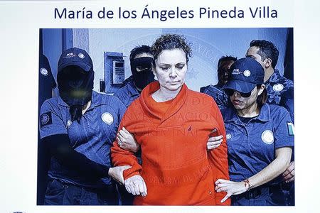 Maria de los Angeles Pineda Villa, the wife of former mayor of Iguala, Jose Luis Abarca, is seen displayed on a television screen during a news conference, while she is transferred to a prison in Tepic, at Nayarit state, in Mexico City in this handout picture released January 5, 2015 by Mexico's Attorney General's Office (PGR). REUTERS/Mexico's Attorney General's Office (PGR)/Handout via Reuters.