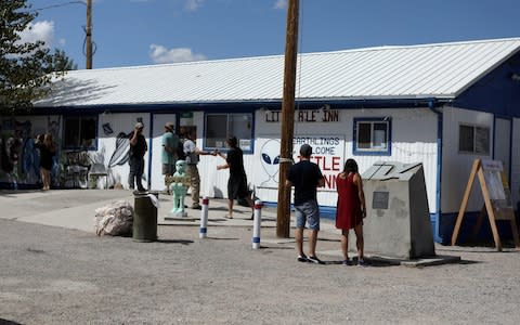 Attendees arrive at the Little A'Le'Inn as an influx of tourists responding to a call to 'storm' Area 51 - Credit: Reuters