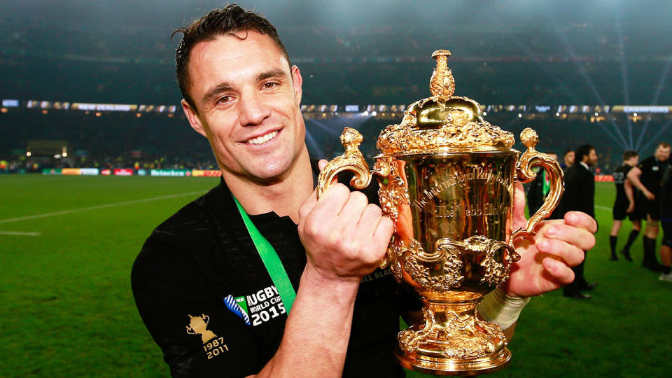 Seen here, Dan Carter poses with the 2015 Rugby World Cup trophy.