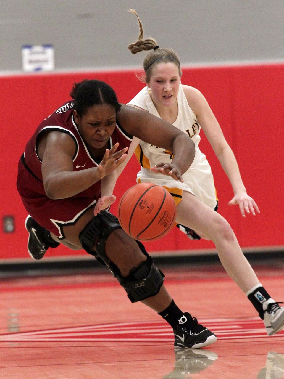 Newark's Syncere Royster and Tri-Valley's Karlee Rose scramble for a loose ball during the Scotties' 49-41 victory in a Division I district semifinal at Johnstown on Wednesday, Feb. 22, 2023.