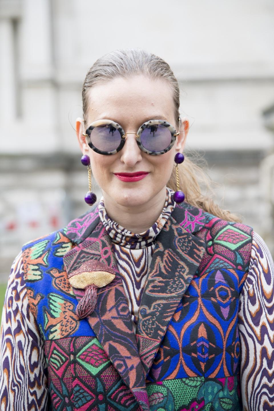 <p>Fashion editor at The Globe Style, Odessa Parker, wears a Philip Sparks coat, Dries Van Noten shirt and Miu Miu sunglasses [Photo: Kirstin Sinclair/Getty Images] </p>