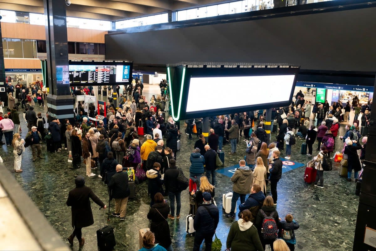 Passengers at Euston Station on Sunday evening (PA)