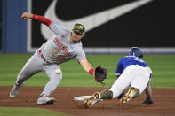 Toronto Blue Jays' Santiago Espinal, right, is caught attempting to steal second base by Cincinnati Reds' Kyle Farmer during the eighth inning of a baseball game Friday, May 20, 2022, in Toronto. (Jon Blacker/The Canadian Press via AP)