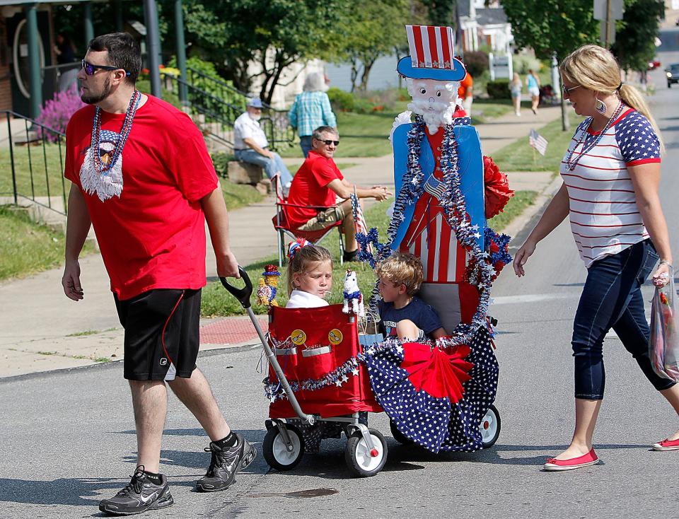 Nick Lavay pulls the wagon decorated with Uncle Sam and carrying Jewels and Jacob Hrinda as their mother, Caroline Hrinda, walks with them as the Push 'em Pull 'em parade makes its way down Center Street last year. The Push 'em Pull 'em parade returns this year on Monday, July 4.