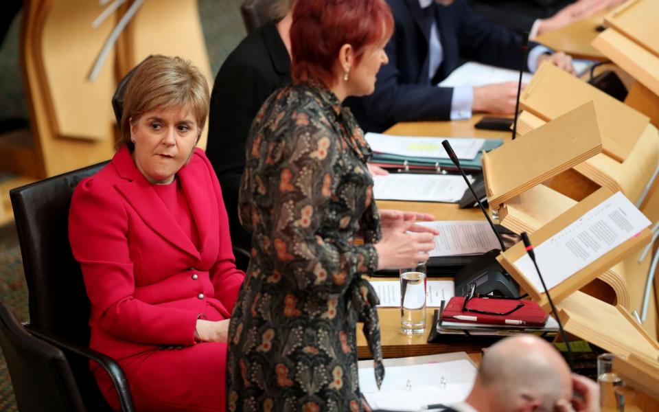 First Minister Nicola Sturgeon (left), in the main chamber of the Scottish Parliament, Edinburgh, during the debate against the UK Government's so-called "rape clause" for tax credits - Credit: PA
