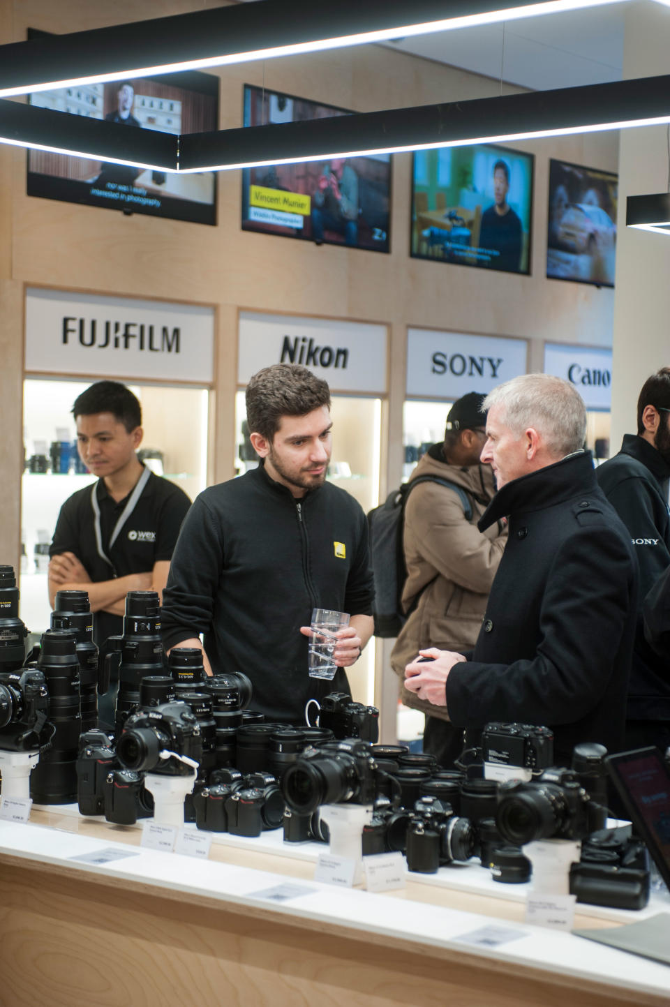Photo showing staff member at Wex Photo Video Putney discussing Nikon camera equipment