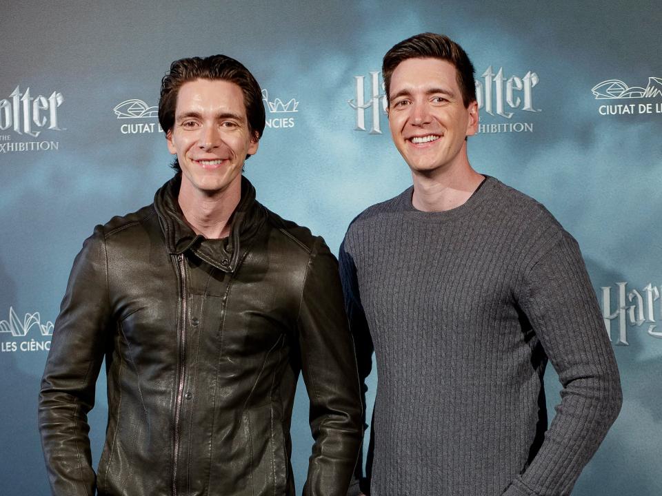 James and Oliver Phelps stand next to each other.