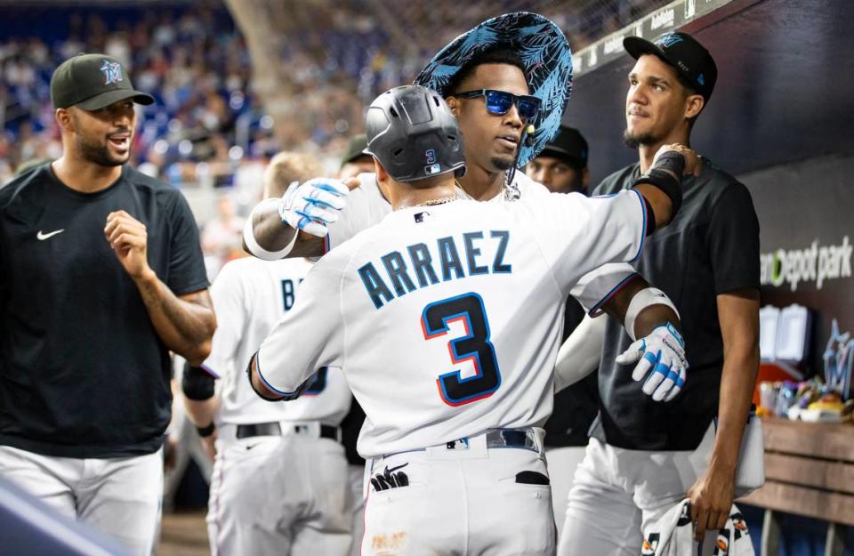 Miami Marlins designated hitter Jorge Soler (12) hugs second baseman Luis Arraez (3) after hitting a home run against the Toronto Blue Jays in the third inning of an MLB game at loanDepot park on Monday, June 19, 2023, in Miami, Fla. MATIAS J. OCNER/mocner@miamiherald.com