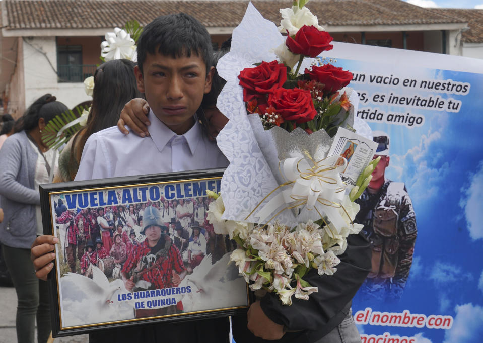 Relatives grieve during the funeral procession of Clemer Rojas, 23, who was killed during protests against new President Dina Boluarte, in Ayacucho, Peru, Saturday, Dec. 17, 2022. The eight deaths this week that converted Ayacucho into the epicenter of violence in Peru's still unfolding crisis is for many a stark reminder of the region's bloody past and longstanding neglect by authorities in the far-away capital.(AP Photo/Franklin Briceno)