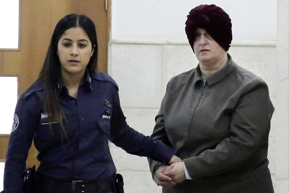 FILE - In this Feb. 27, 2018, file photo, Australian Malka Leifer, right, is brought to a courtroom in Jerusalem. Australia's Prime Minister Scott Morrison said on Wednesday, Oct. 23, 2019, he will raise with Israel's next administration the need for a quick resolution to a 5-year-old extradition battle over an Israeli educator accused of child sex abuse in an Australian school. Morrison issued a statement after meeting at Parliament House with sisters Dassi Erlich and Nicole Meyer, who were allegedly abused by Leifer when she was principal of Melbourne's ultra-orthodox Adass Israel school. (AP Photo/Mahmoud Illean, File)