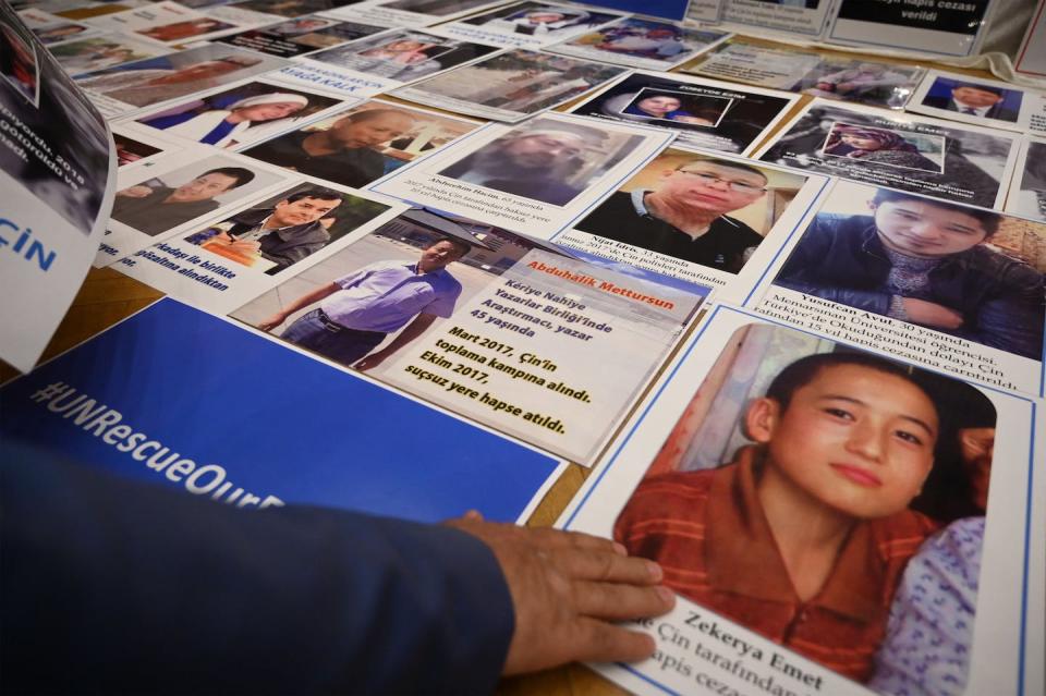Muslim Uyghur people show photos of their relatives who are detained in China in May 2022. <a href="https://media.gettyimages.com/id/1240578147/photo/turkey-un-china-uyghur-justice-rights.jpg?s=1024x1024&w=gi&k=20&c=zISi57__PQF4SmfcyP-uUSOB3FcjfytnqzGd12v4OhQ=" rel="nofollow noopener" target="_blank" data-ylk="slk:Ozan Kose/AFP via Getty Images;elm:context_link;itc:0;sec:content-canvas" class="link ">Ozan Kose/AFP via Getty Images</a>