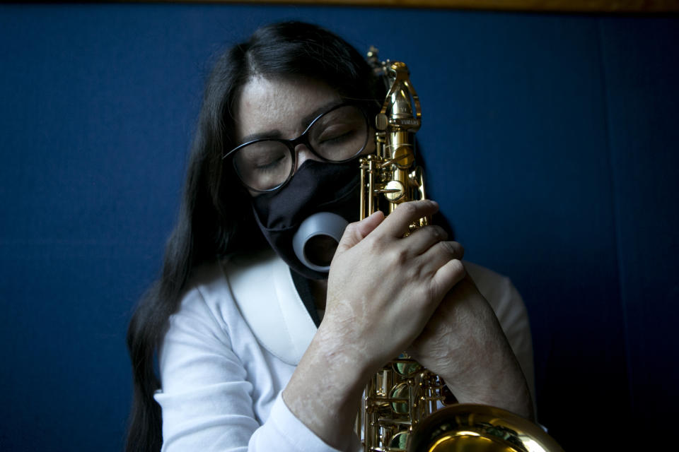 Maria Elena Ríos holds her saxophone at the end of a rehearsal at the National Autonomous University of Mexico music department, in Mexico City, Tuesday, Feb. 14, 2023. Ríos, 29, thought her career as a musician and her devotion to hersaxwas what ledherformer boyfriend and politician to hire the men who splashed acid into her faceand body, disfiguring her in 2019. Later, she learned that he simply couldn't accept that she had broken off their relationship. (AP Photo/Ginnette Riquelme)