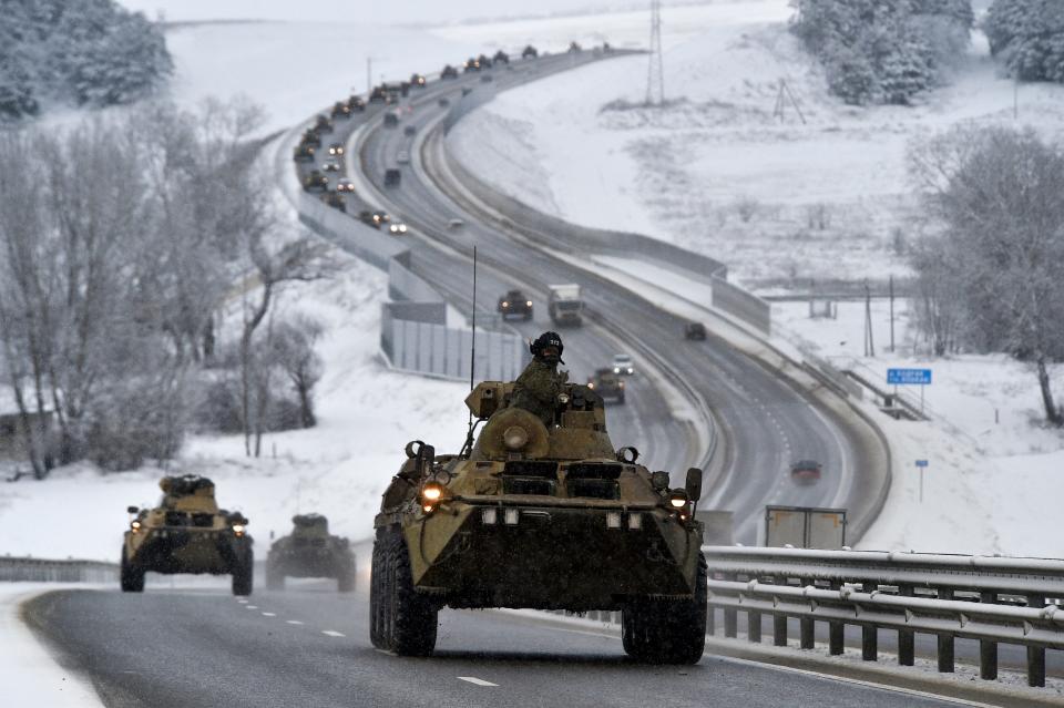 A convoy of Russian armored vehicles moves along a highway in Crimea, Tuesday, Jan. 18, 2022. Russia has concentrated an estimated 100,000 troops with tanks and other heavy weapons near Ukraine in what the West fears could be a prelude to an invasion. The Biden administration is unlikely to answer a further Russian invasion of Ukraine by sending U.S. combat troops. But it could pursue a range of less dramatic yet still risky options, including giving military support to a post-invasion Ukrainian resistance.