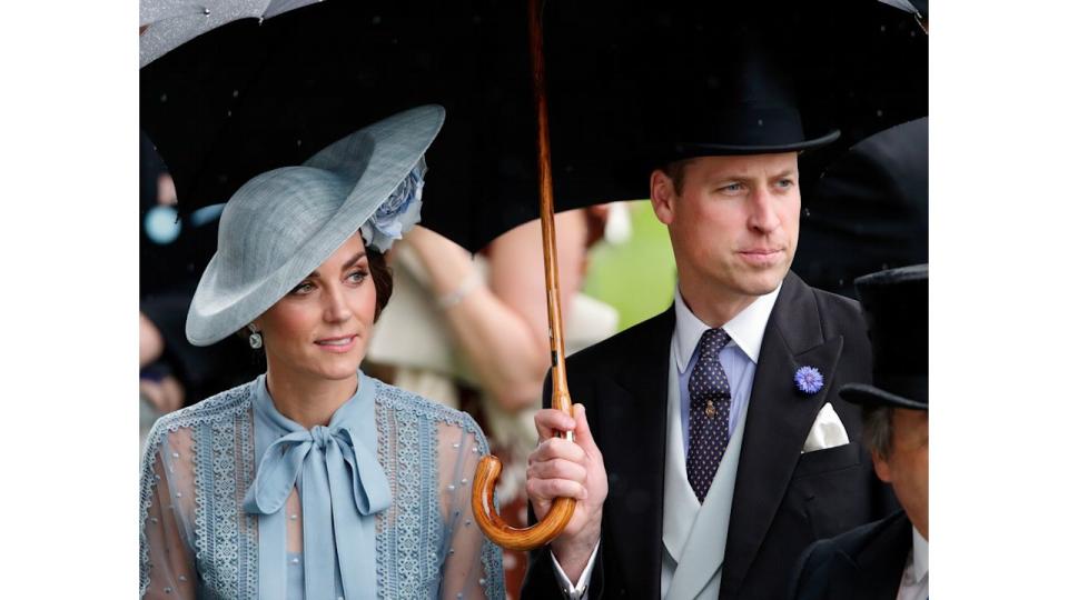 Princess Kate and Prince William shelter under an umbrella as they attend day one of Royal Ascot at Ascot Racecourse on June 18, 2019 in Ascot, England.