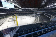 Worker Raul Camacho clean seats inside the newly constructed Globe Life Field in Arlington Texas, Wednesday, March 11, 2020. The Texas Rangers are scheduled to play their home opener in their new home on March 31 against the Los Angeles Angels. (AP Photo/Tony Gutierrez)