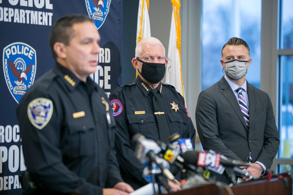 Police Chief Dan O'Shea, left, identifies the suspected shooter in a triple homicide as Duke Webb of Florida during a news conference Dec. 27 in Rockford, Ill.